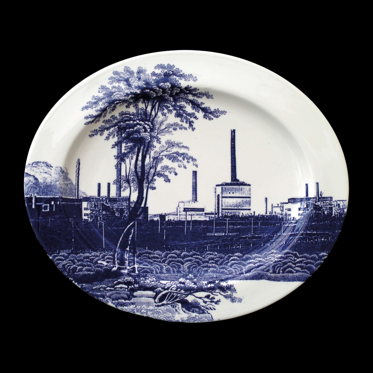 Cumbrian Blue(s), Sellafield No:9, 5/5. Transfer print collage on bone china platter with platinum, 410mm x 345mm x 24mm. Paul Scott 2005.